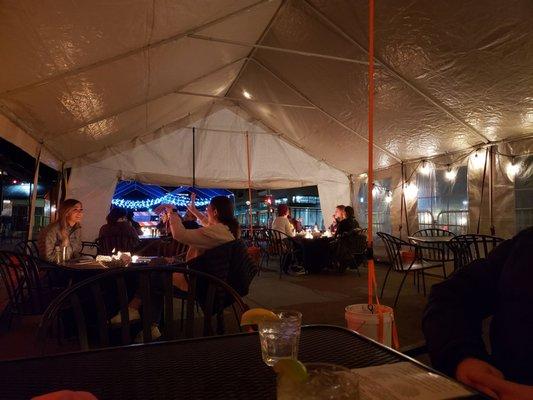 Outside tent with firepit tables