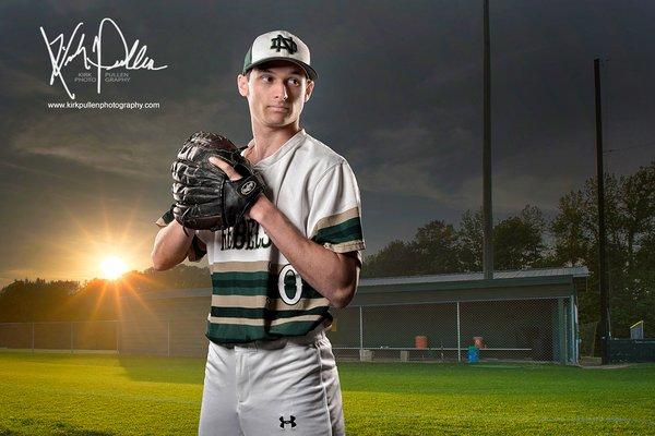 Creative photo session of a senior baseball player on the field with the sunset.