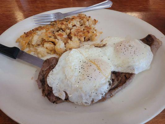 Two eggs over easy, hash browns and a ribeye medium rare.