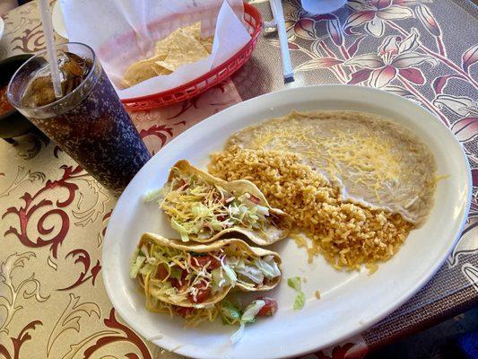 Two tacos with rice and beans, everything prepared to perfection.