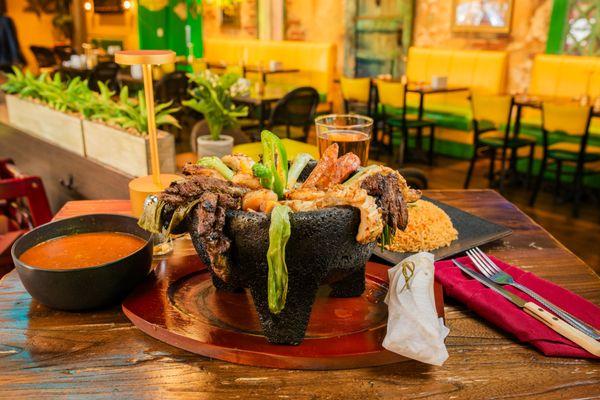 Molcajete
Chicken breast, grilled skirt steak, shrimp, and sausage, fried nopal tips, celery and jalapeno. Served with three sides.