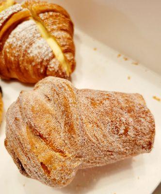 Black Tea Cruffin.. is shaped like a tall top hat, cinnamon sugar outside, croissant texture inside with a delicious creamy filling.