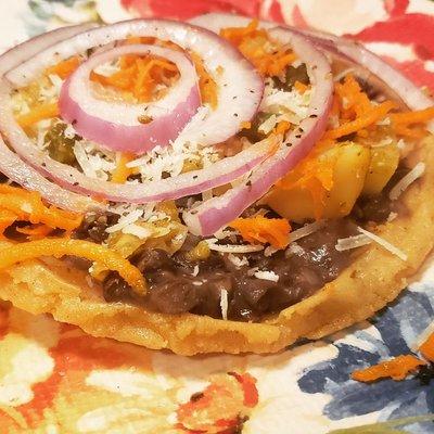 Black beans and zuccini blossoms sope, cured red onions, sasoning carrots with cream