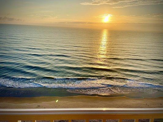 Beautiful beachfront directly outside hotel.  View from the balcony at sunrise.