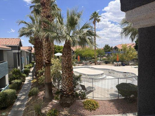 Pool at St Lucia Apartments (drained because they resurfaced the pool June of 2023) added new furniture too.