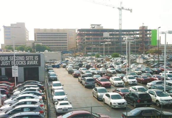 Endless hospital construction as seen with the employee parking lot in the foreground.