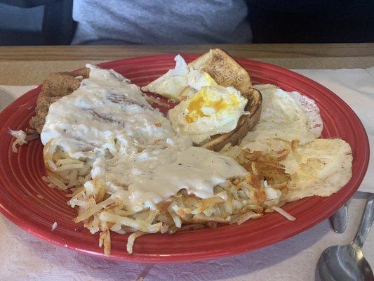 Chicken fried steak with ver easy eggs.