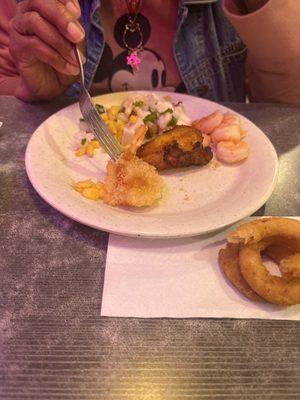 A mix plate with shrimp scampi, seafood salad, fried shrimp and sweet plantain.