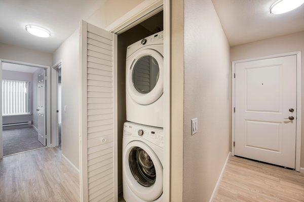 Stackable washer and dryer in storage closet.