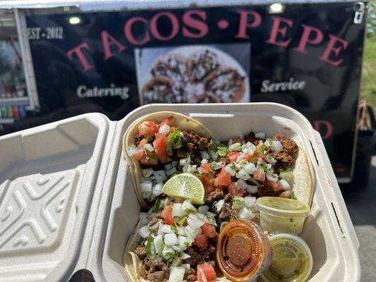 Pastor and carnitas tacos with red & green hot sauce.