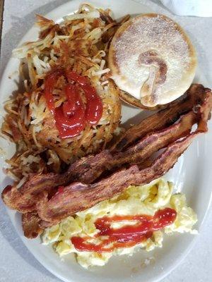 Two egg breakfast, crispy bacon, English muffin, scrambled eggs.