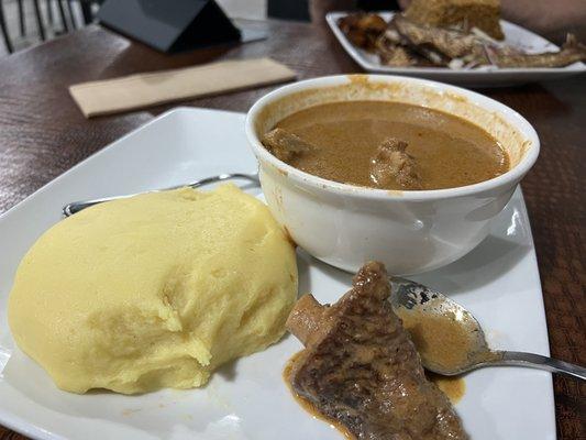 Palmnut Soup & Fufu - flavorful, a bit spicy, rich and delicious. Couldn't resist pinching off some fufu before I took this pic.