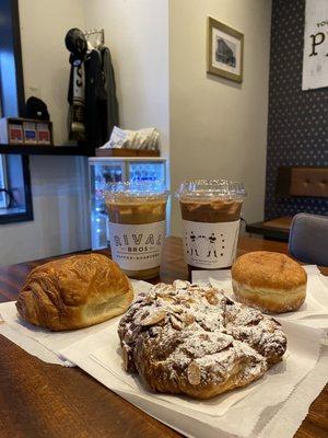 Latte (w oat milk and iced),  Mocha (w oat milk and iced), (left to right): chocolate croissant, almond croissant, beignet