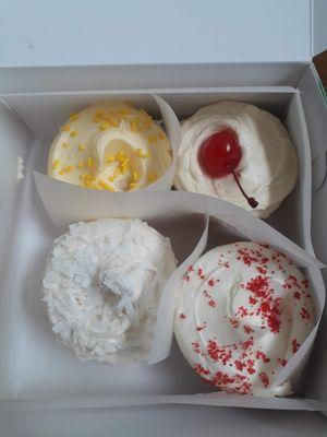 Clockwise from top left: lemon, pineapple upside down, red velvet, coconut.