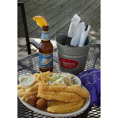 One of our specialities, fried catfish served with slaw, french fries, hush puppies, and tater sauce.