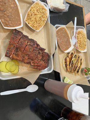 Ribs, pinto beans, Spanish rice, pickles, onions. Brisket taquitos, beans, rice, lime, pico de gallo. BBQ sauce on the side.