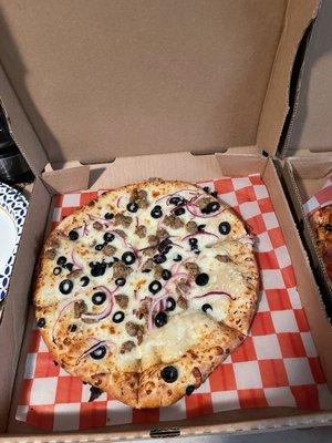 Customize a thicker crust olive oil black olives and Italian sausage delicious