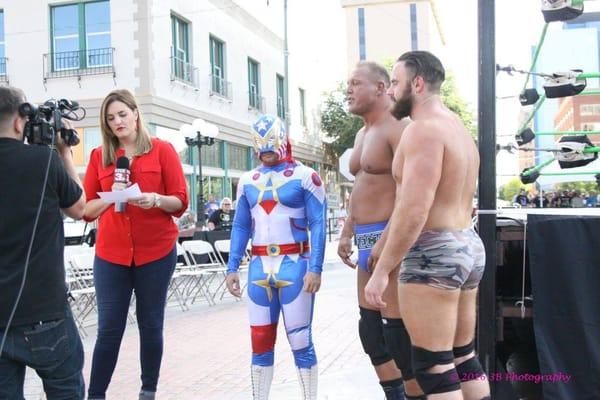 Taylor Newsome with KFDX waits to interview the guys before the Wrestling Under the Stars matches in downtown Wichita Falls, TX