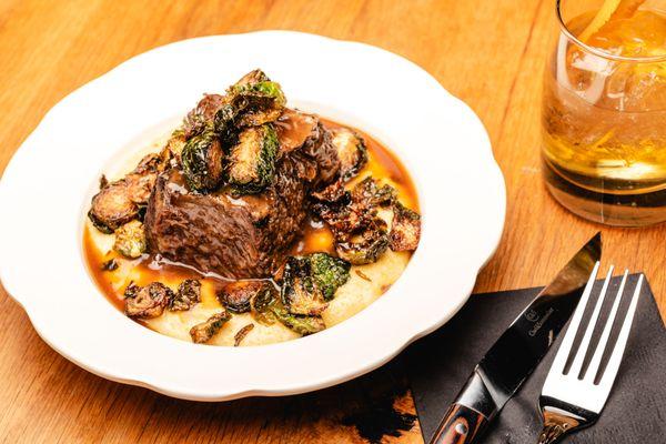 Braised Short Rib w/cheddar polenta, crispy brussels sprouts,natural jus