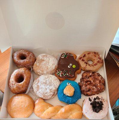 Dozen donuts plus one in a separate bag.