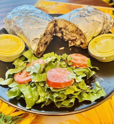 Brasa Burrito with salad and green and yellow sauce