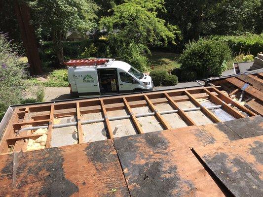 Simultaneously installing electrical in a flat roof while the roofers where replacing the roof.