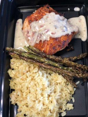 Grilled salmon with rice pilaf and asparagus and a creamy dill sauce