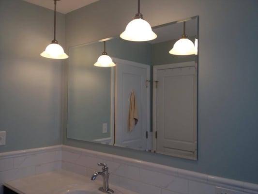 Frameless and floating beveled mirror.