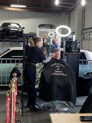 Christi cutting hair with Macklemore's Cadi in the background