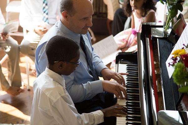 Father and son performing a piano duet!