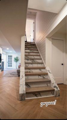 Custom Stair Installation with porcelain risers and shiplap walls. Herringbone flooring