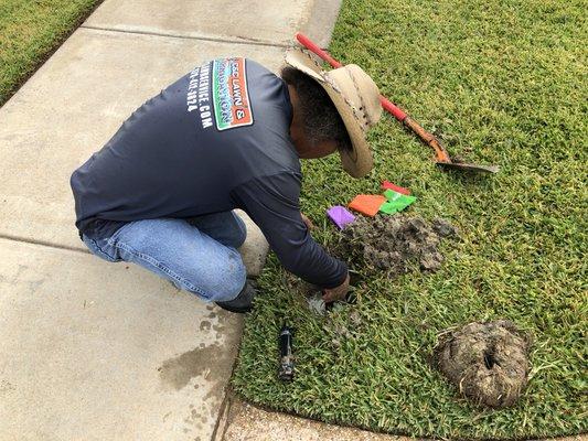 Repairing sprinklers.