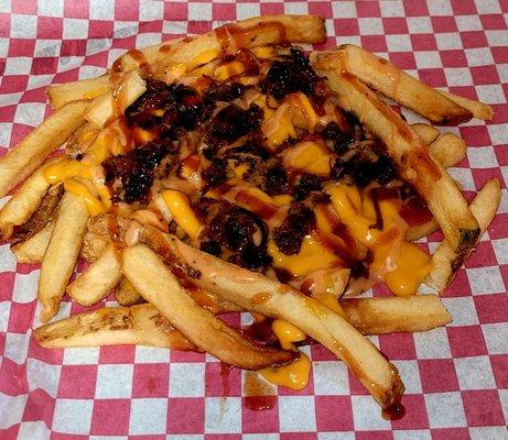 Hot Mess Fries: our famous french fries topped with Cheddar Cheese Sauce, Chopped Meat and our own Long BBQ Sauce and our 7 Sauce.