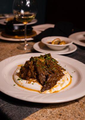 Marinated tenderloin steak topped over garlic yogurt, and fried onions.