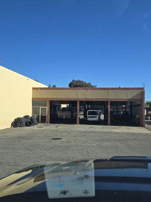 An empty shop 2 guys on duty looking at one vehicle.