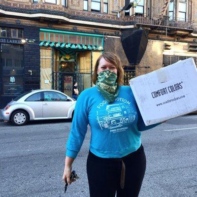 Nicole in front of her shop with our completed order, rocking one of the vintage shirts she printed for us!