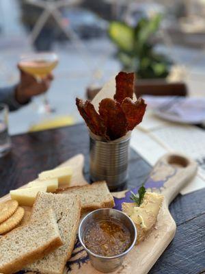 Cheeseboard w/ 6 cheeses Sweet and Spiced Candied Bacon. Cheeseboard changes, but ours came with gooseberry jam and herbed focaccia