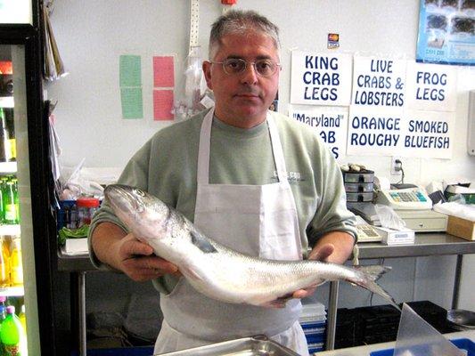 Eddie holding a fish at Courthouse Fish Market