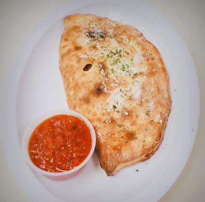 Calzone with a side of homemade marinara sauce