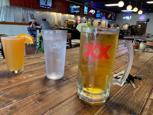 Large cold beer, water and regular sized beer