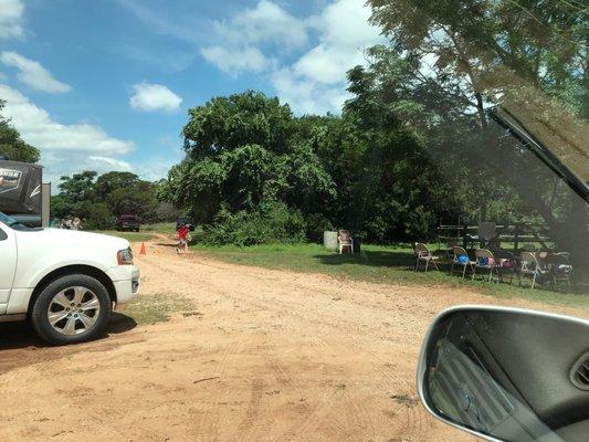 Dirt road leading to the stables, with parking areas along side.