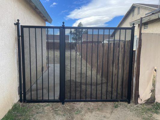 After: gate with perforated meshing. Added bar to fix larger fence panel