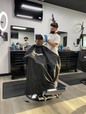 Roman hard at work. One of the best haircuts my son has gotten EVER.