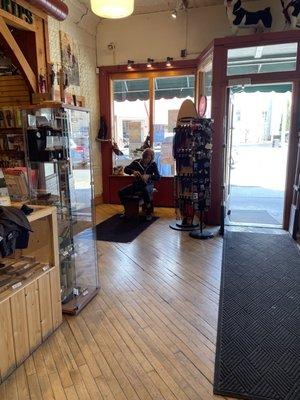 She's literally stitching the leather moccasins right there in the store!