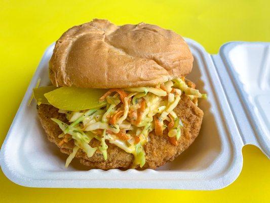 Fish sandwich, served with vegan slaw, pickles, and a tartar sauce on the side!