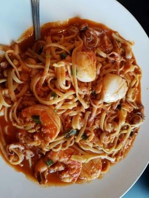 Seafood Special Scallops, Shrimp, Calamari in garlic red sauce over linguini.