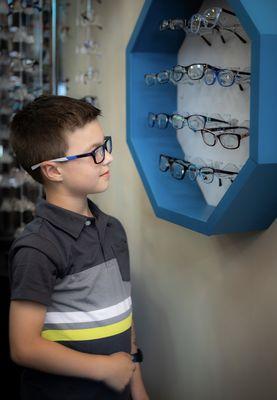 Family practice with selection of adult and children's eyeglass frames.