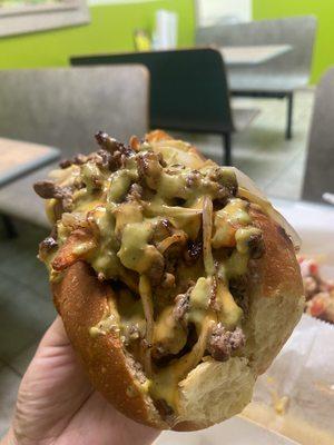 Close up of the Philly cheesesteak-- lots of meat and there's fries in there, too.