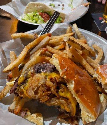 Western burger with steak taco in the background. Delicious!