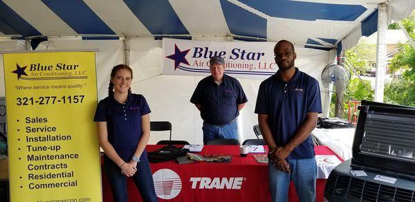 Blue star employees standing at a booth during India festival